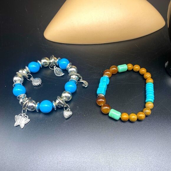 Bundle of 7” stretch bracelets with one having turquoise beads and charms… - Picture 1 of 11